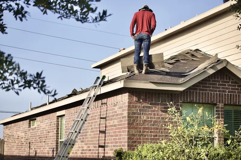 Professional roofer working on a residential roof in Mont Vernon